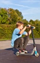 Boy jumps with scooter at the skate park Royalty Free Stock Photo