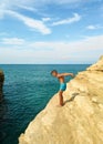 A boy jumps into the sea from a sand cliff. Sidari beach, Canal d`Amour Channel Of Love , Corfu island, Greece, Europe.