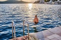 The boy jumps into the sea from a stone pier at sunset Royalty Free Stock Photo