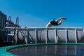 Boy jumps in a swimming pool in the garden Royalty Free Stock Photo