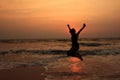 A boy jumps in the waves during sunset Royalty Free Stock Photo