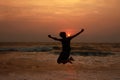 A boy jumps in the waves during sunset Royalty Free Stock Photo