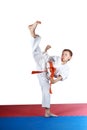 Boy in karatege is doing high kick leg Royalty Free Stock Photo