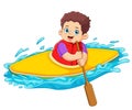 A boy kayak adventure using holding paddle Royalty Free Stock Photo