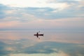 A kayaker swims along the estuary at sunset