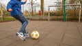 Boy kicking ball at goal