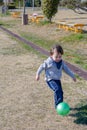 Boy Kicking Ball at Park Royalty Free Stock Photo