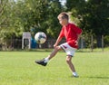 Boy kicking football