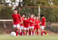 Boy kicking football on the sports field