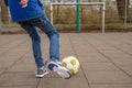 Boy kicking football