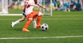 Boy Kicking Soccer Ball. Running Soccer Football Players. Five Junior Footballers on Duel