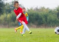 Boy kicking soccer ball Royalty Free Stock Photo