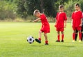 Boy kicking soccer ball at training Royalty Free Stock Photo