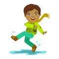 Boy Kicking Water With Foot, Kid In Autumn Clothes In Fall Season Enjoyingn Rain And Rainy Weather, Splashes And Puddles Royalty Free Stock Photo