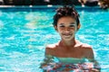 Boy kid child eight years old inside swimming pool portrait happy fun bright day Royalty Free Stock Photo