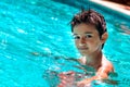 Boy kid child eight years old inside swimming pool portrait happy fun bright day Royalty Free Stock Photo