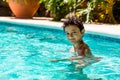 Boy kid child eight years old inside swimming pool portrait happy fun bright day Royalty Free Stock Photo