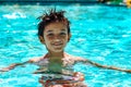 Boy kid child eight years old inside swimming pool portrait happy fun bright day