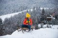 Boy kid enjoying a sleigh ride. Child on sleigh. Child plays outside in the snow. Winter, holiday and Christmas time Royalty Free Stock Photo