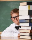 Boy kid, happy and portrait with books, classroom and learning for exam, assessment and studying for knowledge. Student Royalty Free Stock Photo