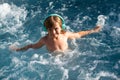 Boy kid happy swimming in a pool. Summer child.