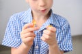 Boy, kid holding sweets in his hands, gummy bear, concept of children`s delicacy, healthy and unhealthy food, halal food