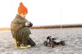 Boy kid playing radio control car riding on sand outdoor enjoying happy childhood Royalty Free Stock Photo