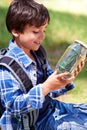 Boy, kid and smile with jar in nature, exploring and learning on adventure, hiking in park or woods for fun. Happy Royalty Free Stock Photo