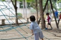 Boy kid in uniform play ropr climb in playground international Royalty Free Stock Photo