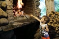 Boy kindles fire in fireplace Royalty Free Stock Photo