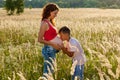 The boy is kissing the belly of his mother Royalty Free Stock Photo