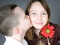 Boy kissing girl with flower Royalty Free Stock Photo