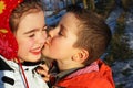 Boy kissing a girl, hearts around