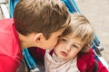 Boy giving a kiss to a little girl