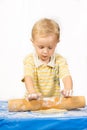 Boy knead the dough by hand for making a cake