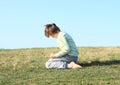 Boy kneeling on meadow Royalty Free Stock Photo