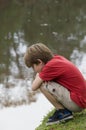 Boy by a lake Royalty Free Stock Photo