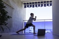 Boy with laptop computer doing sport exercises on balcony. Sport, healhty lifestyle, active leisure at home