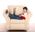 Boy with laptop and headphone. Royalty Free Stock Photo
