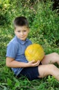 A boy with a large melon Royalty Free Stock Photo
