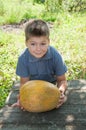 A boy with a large melon Royalty Free Stock Photo