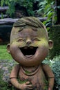 Boy is laughing statue in flower garden Royalty Free Stock Photo