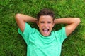 Boy laughing teenager laying green grass Royalty Free Stock Photo