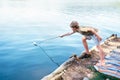 Boy launches the paper boat in lake Royalty Free Stock Photo