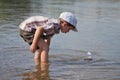 Boy launches a small sailboat