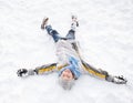 Boy Laying On Ground Making Snow Angel Royalty Free Stock Photo