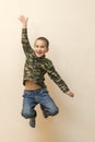 Boy laying in the house. children playing at home. jumping children. vertical photo. toned Royalty Free Stock Photo