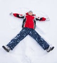 Boy laying in star shape in snow Royalty Free Stock Photo