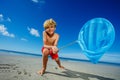 Boy lean holding butterfly net catching critters on beach