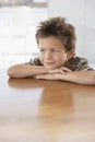 Boy Leaning On Wooden Dining Table Royalty Free Stock Photo